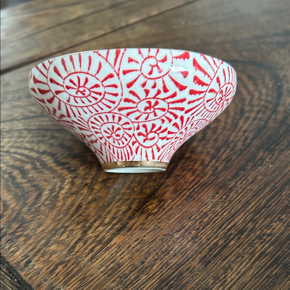 Elegant ceramic bowl with intricate blue swirl design. Perfect for home decor.